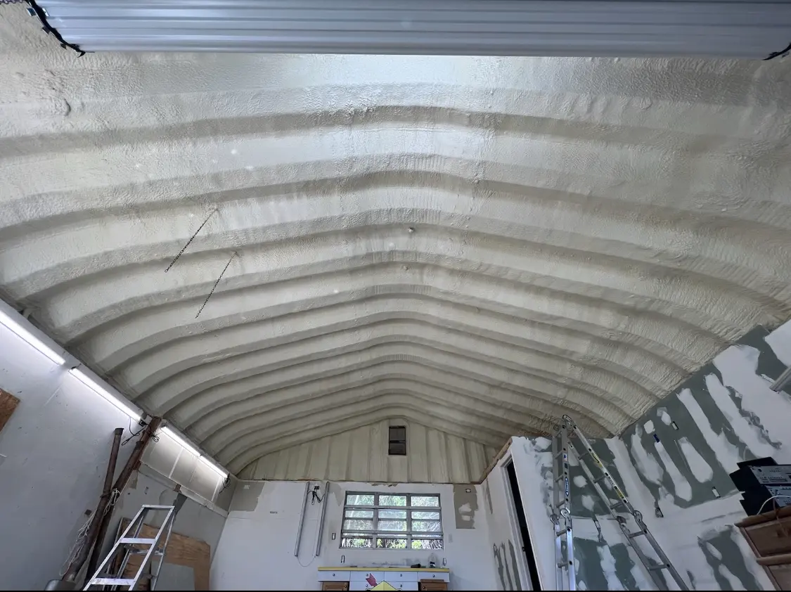 Spray polyurethane foam applied to the underside of a metal roof deck in Raton